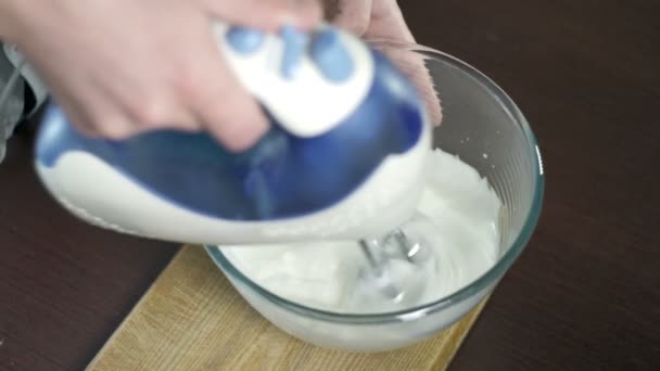 Beating egg proteins in the glass bowl. Process of whipping proteins eith mixer - Footage, Video