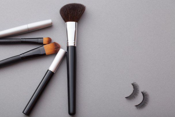 Beautiful makeup on a gray background. - Foto, Imagen