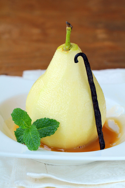 Fruit dessert, a pear in caramel sauce - Fotó, kép