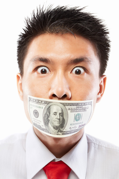 Bribe concept, mouth sealed with dollar bill - 写真・画像