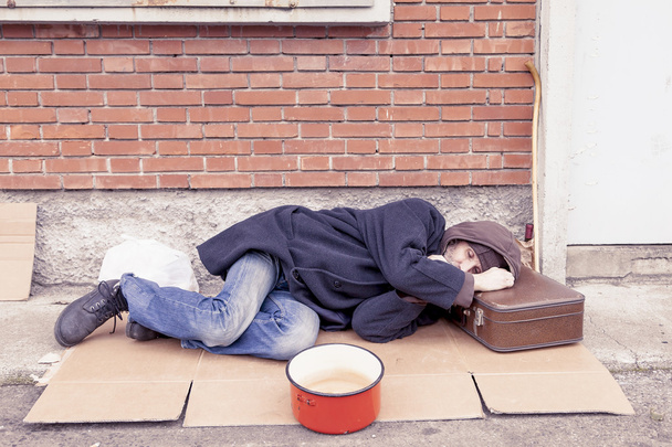 homeless sleeping on a cardboard in landfill - Фото, изображение