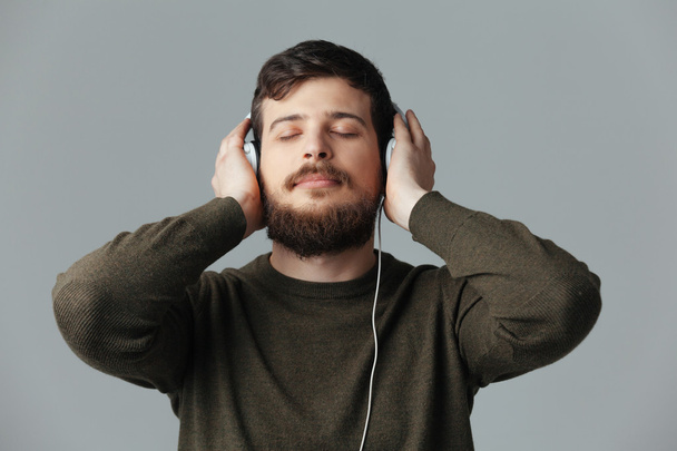 Man listening music in headphones  - Φωτογραφία, εικόνα