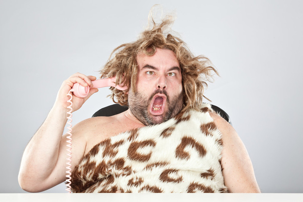 ugly rude prehistoric man with phone in his hair  - Foto, Bild