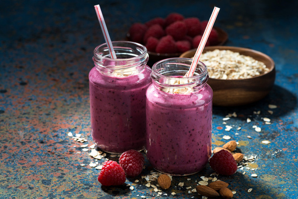 healthy berry smoothies with oatmeal on a dark background - Fotó, kép