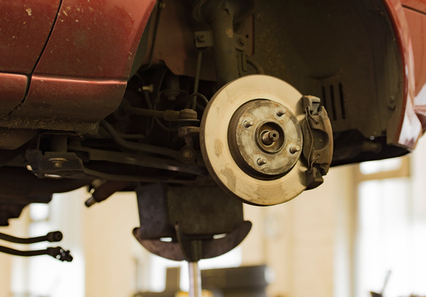 Car repair on a lift in a car workshop - Foto, immagini
