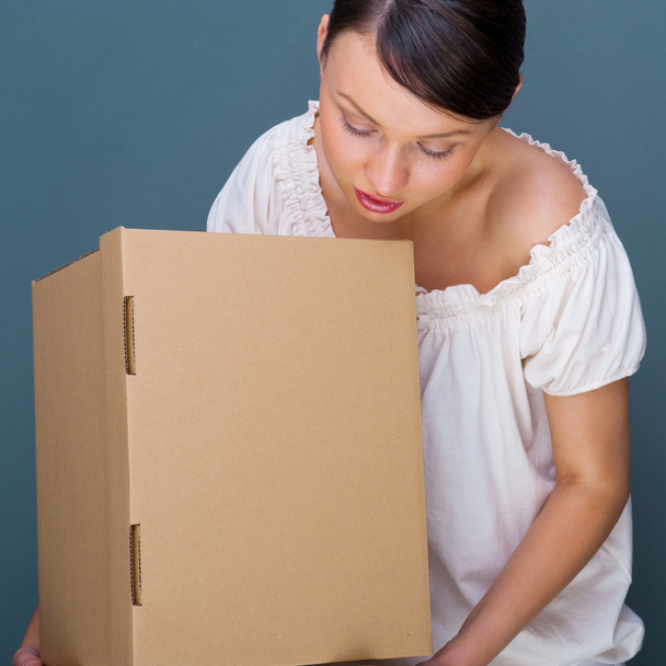 Closeup portrait of a young woman with boxes - Photo, Image