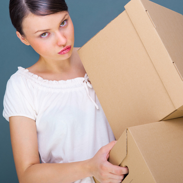 Closeup portrait of a young woman with boxes - Zdjęcie, obraz
