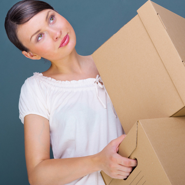 Closeup portrait of a young woman with boxes - Zdjęcie, obraz