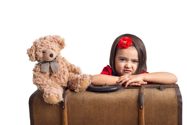 Capricious beautiful little Girl with suitcase and toy bear - Foto, immagini