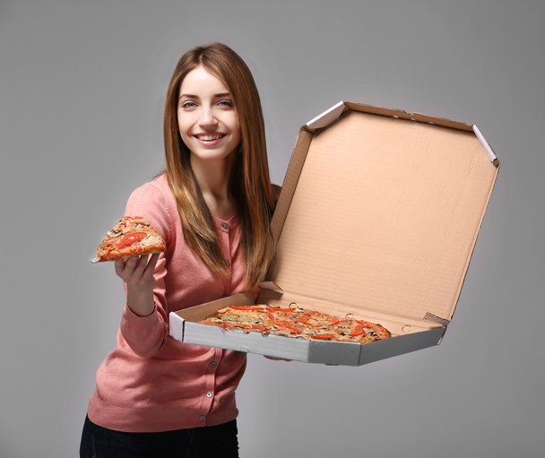 woman holding hot pizza - Фото, изображение