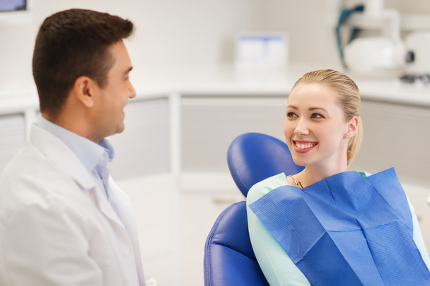 happy male dentist with woman patient at clinic - 写真・画像