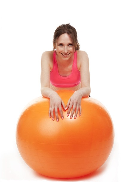 Young woman resting with a fitness ball - Foto, imagen