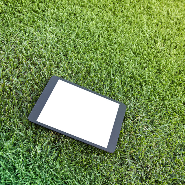 Blank tablet on the grass - Фото, изображение