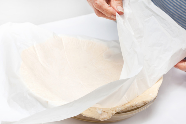 Transferring the quiche Lorraine dough to the glass baking dish - Фото, изображение