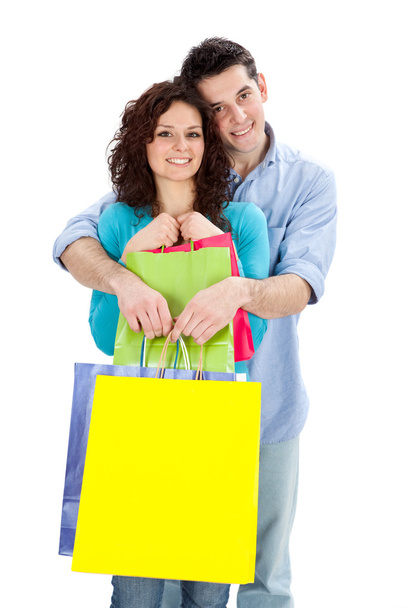 young beautiful couple in love with shop bag isolated on white - Fotoğraf, Görsel