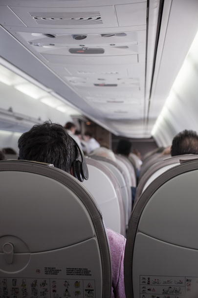 Interior of airplane with passengers  - 写真・画像