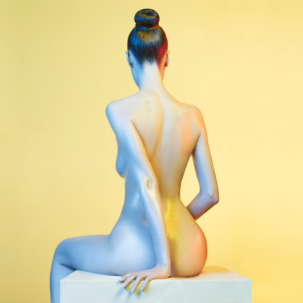 Elegant nude model in the light colored spotlights - Fotó, kép