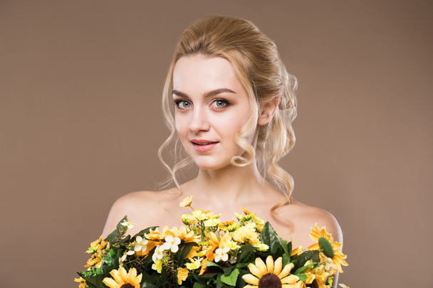 portrait of a girl with flowers in hand - Photo, image