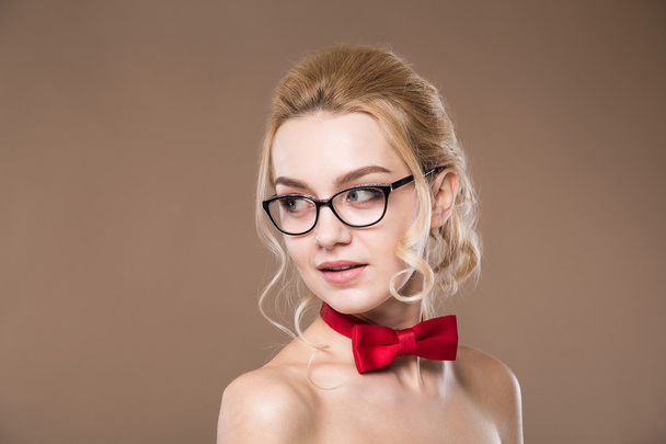 woman in glasses with red butterfly on her neck - Foto, afbeelding
