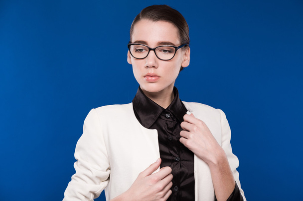 girl with glasses on a blue background - Photo, Image