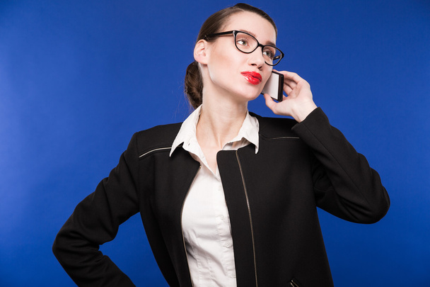 young woman with glasses talking on the phone - Foto, imagen