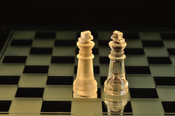Chess pieces on a glass board - Photo, Image