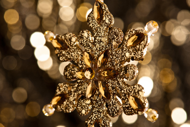 künstliche Schneeflocke in Gold - Foto, Bild
