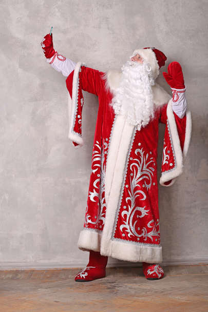 Дед Мороз держит мобильный телефон, делает селфи
. - Фото, изображение