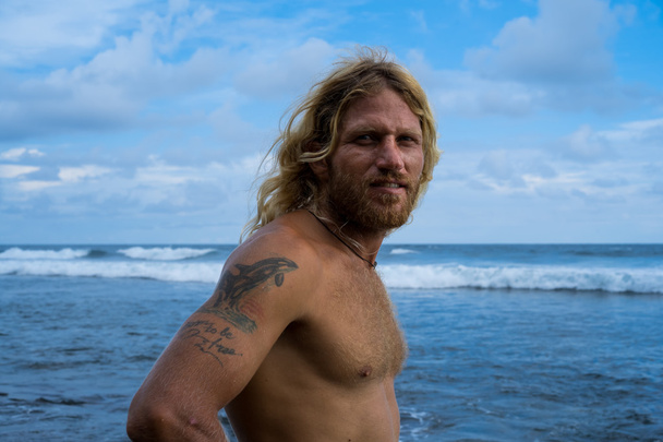 Brutal man surfer with long white hair . - 写真・画像
