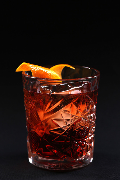 Old fashioned Negroni cocktail on the black background. - Фото, изображение