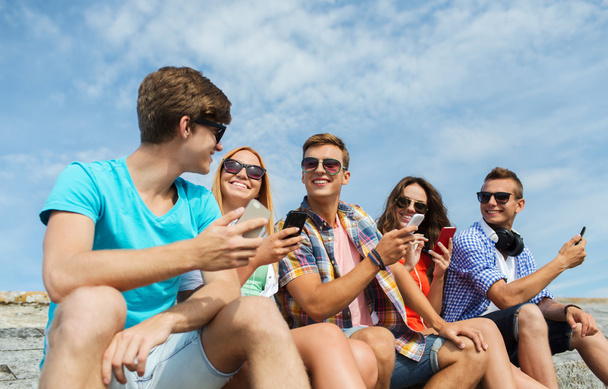 group of happy friends with smartphones outdoors - Photo, Image
