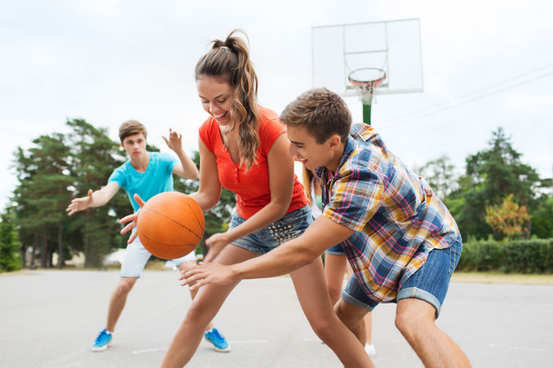 group of happy teenagers playing basketball - Φωτογραφία, εικόνα