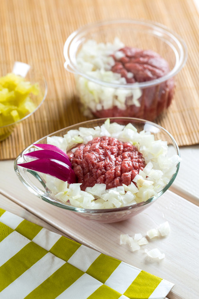 Dish with raw seasoned meat called "Tatar" with chopped onion - Photo, Image