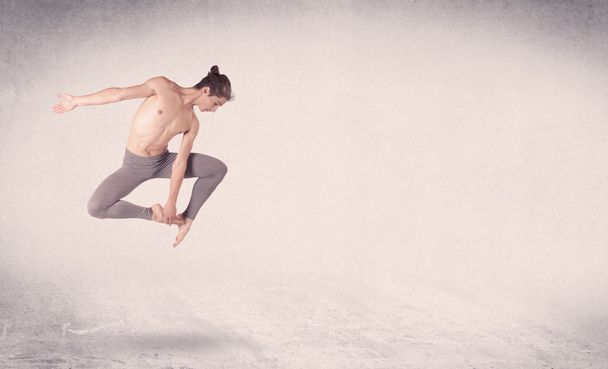 Modern ballet dancer performing art jump with empty background - Zdjęcie, obraz