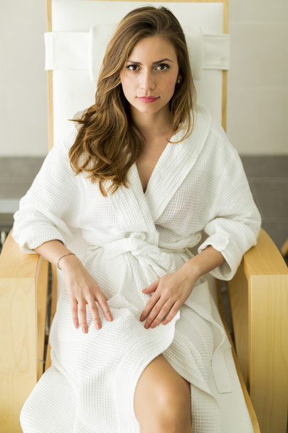 Young woman relaxing in a robe - Fotó, kép