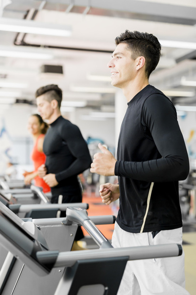Group of people using treadmills in a gym - Fotó, kép