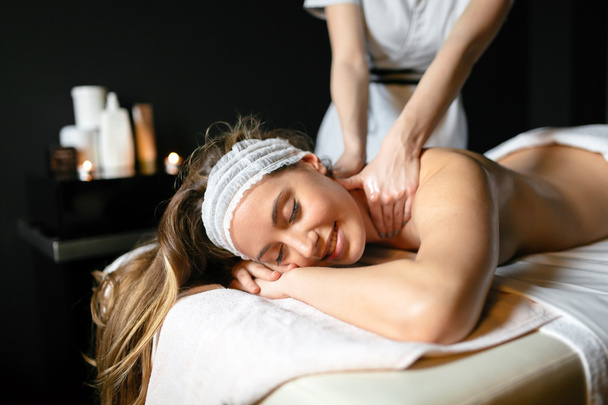 Massage therapist massaging woman - Valokuva, kuva