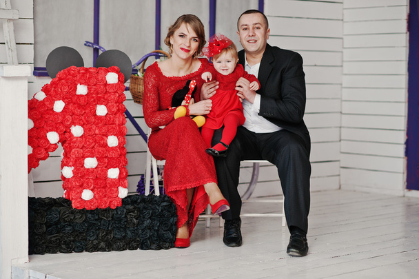 Happy family and daughter sitting on a chair near decor, backgro - Фото, изображение