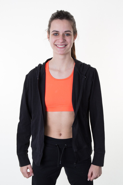 Menina do esporte vestindo top laranja fazendo esporte
  - Foto, Imagem