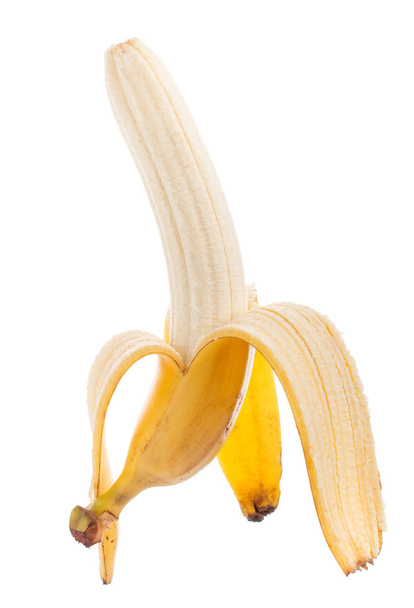 白い背景上に分離されて半分皮をむいたバナナ - 写真・画像