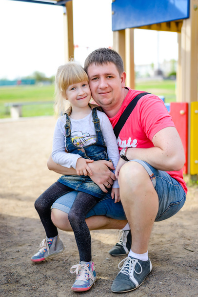 Cute little girl sitting on knee of father - Photo, Image