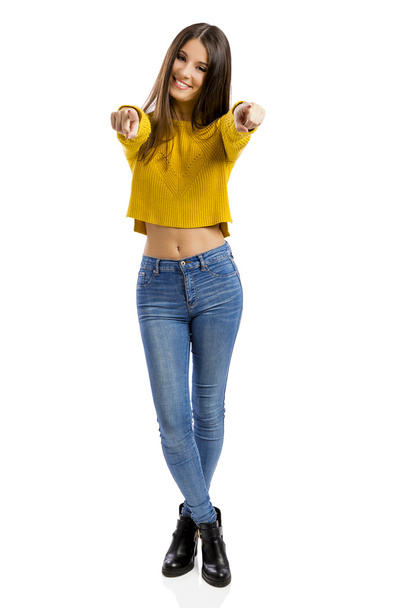 Teenage girl pointing towards camera - Фото, изображение