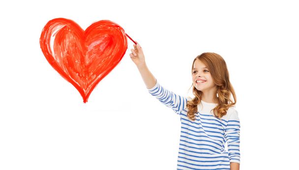 girl drawing big red heart in the air - Photo, image