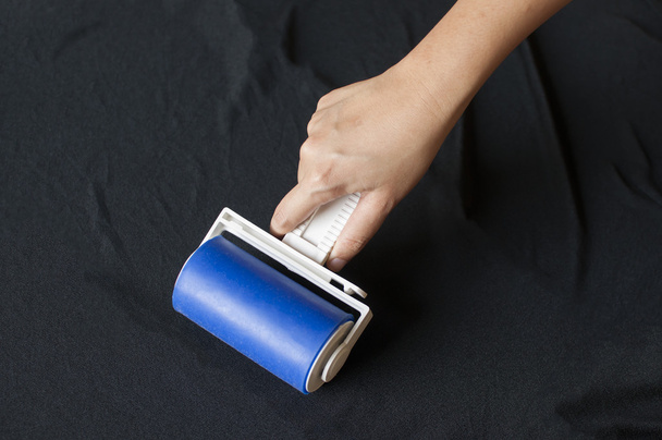 Lint roller on black cloth. - Photo, Image