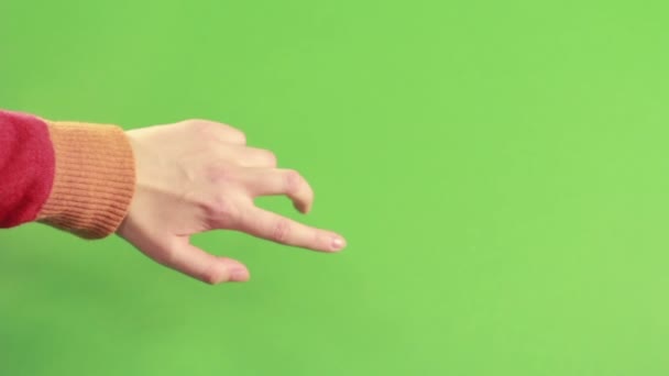 Gest dłoni na białym tle na zielonym tle w studio - Materiał filmowy, wideo