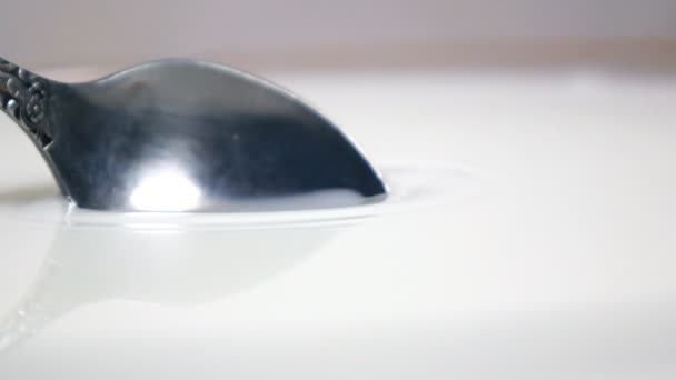 Scooping up milk with spoon - Footage, Video