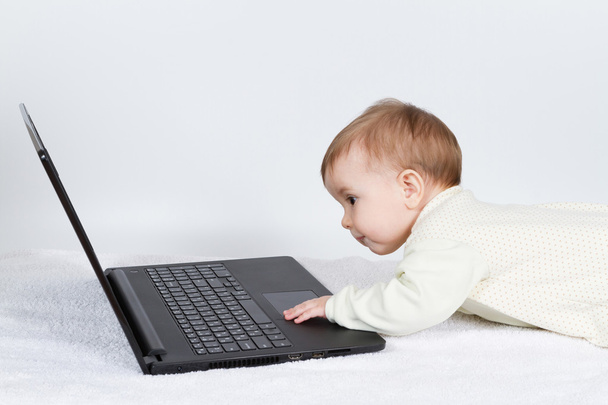 Cute baby boy with black laptop - Photo, Image