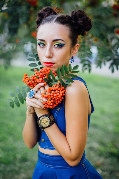 Beautiful young woman with rowan berries - Фото, изображение