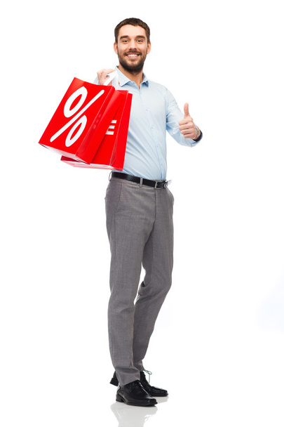 smiling man with red shopping bag - Фото, изображение