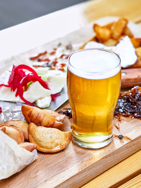 Beer with fried dumplings and cheese with grated beetroot  - Photo, image